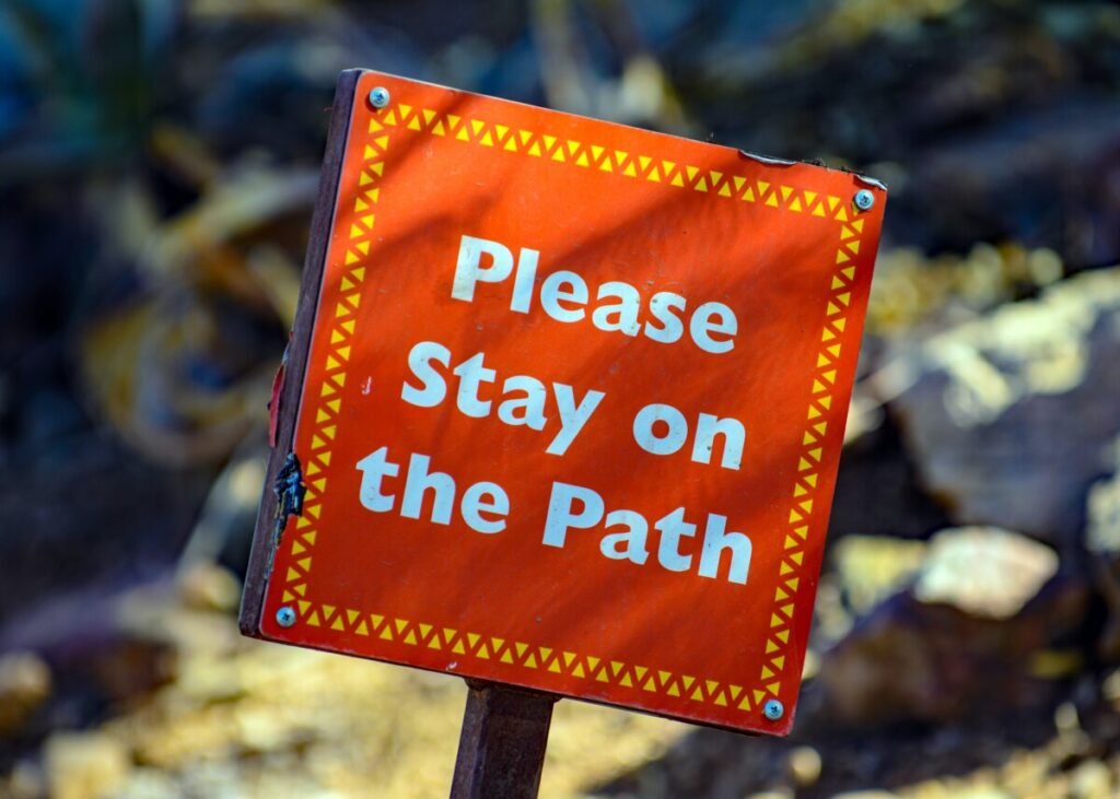 Sign 'please stay on the path' - photo: Unsplash