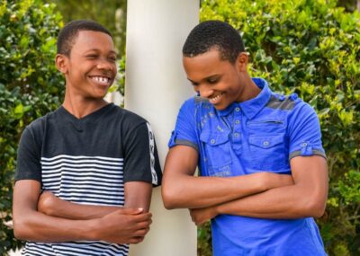 Two Black teenage boys laughing. Photo: Unsplash