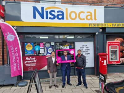 Retailers from a Nisa store stand outside their shop