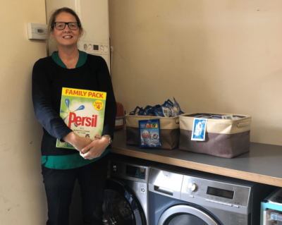 Rachel Miller in front of the new laundrette facilities funded by Castle Cavendish