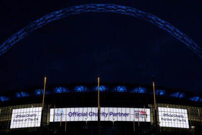 Signs outside Wembley Stadium announce Alzheimer's Society as The FA's official charity partner