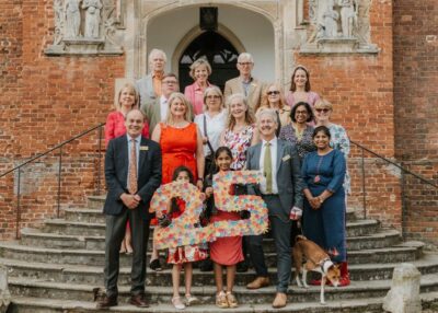 A group of people outside a building at Stonor Park, celebrating the National Garden Scheme's 25th anniversary of charity partnerships