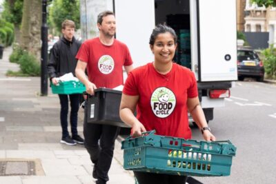 Foodcycle volunteers carrying food donations