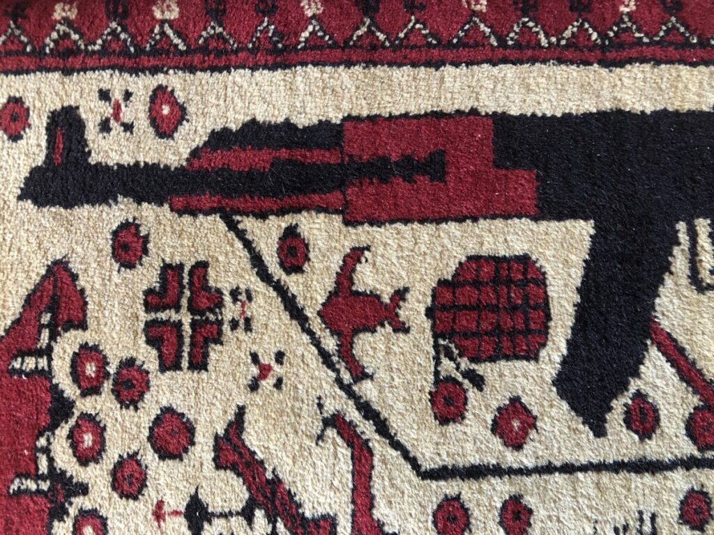 Afghan rug with depictions of armed conflict. Photo: Howard Lake