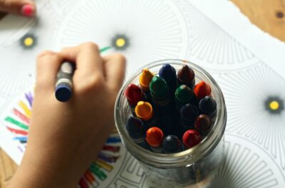 A child colouring with crayons