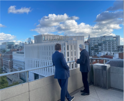Paul Marshall & Stephen Chambers stand on the top of a tall building looking over to the new Marshall Building
