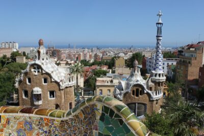 A view over Barcelona from the brightly coloured terrace of Parc Guell