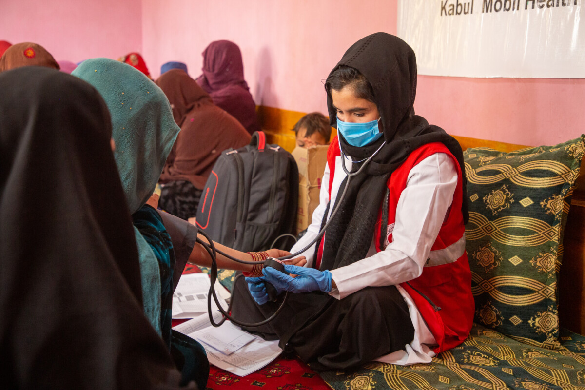 A midwife from one of Afghan Red Crescent's mobile health teams conducts health checks during a regular community visit. Photo: Afghan Red Crescent/Meer Abdullah