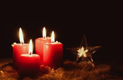 a group of 4 red christmas candles and a star
