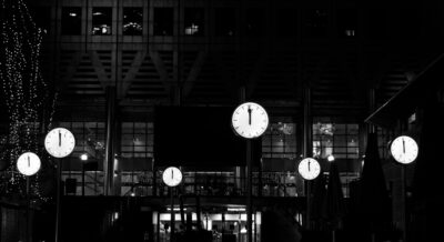 Clocks at one minute to midnight. Photo by alexandru vicol on Unsplash
