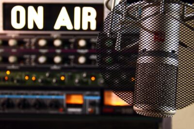 Live on air sign near recording equipment. Photo: Pexels.com