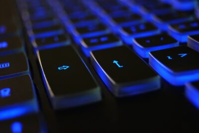 black laptop keys backlit in blue