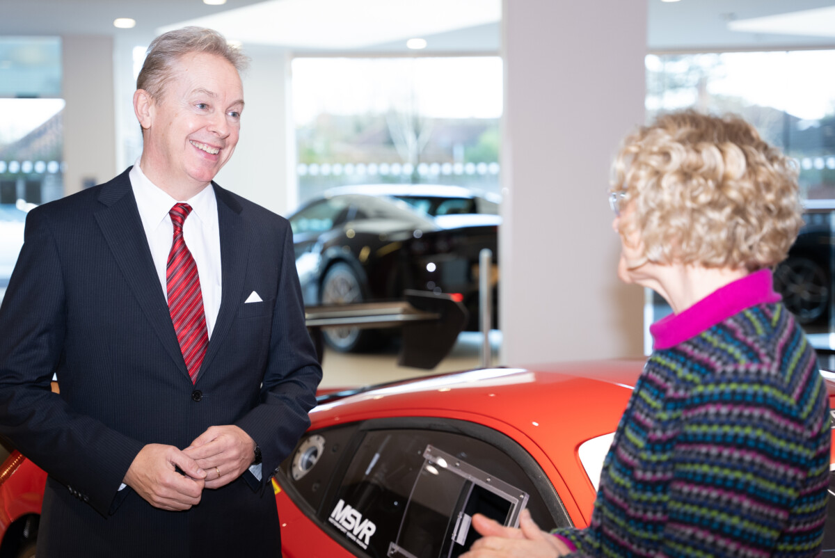 Sytner Group Director of HR Melvin Rogers & CEO of Ben Zara Ross talk by a red car