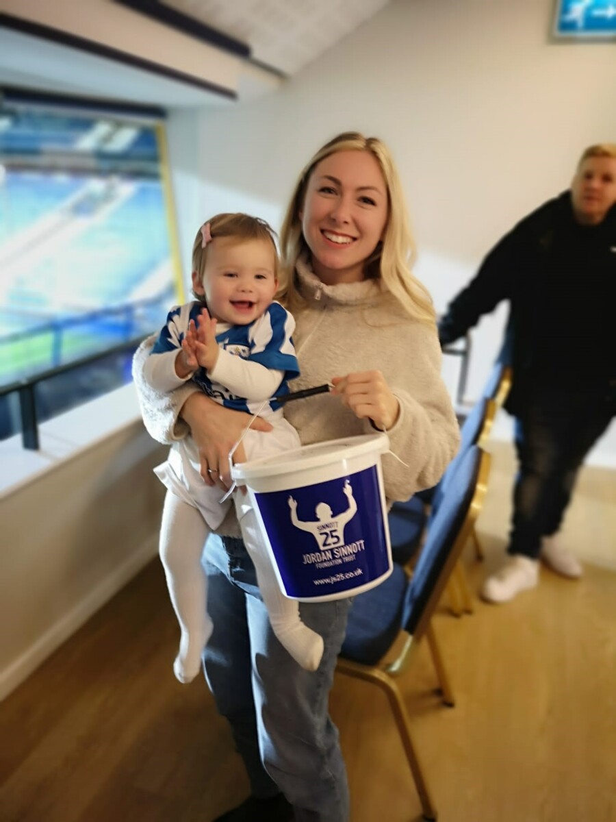 Jordan Sinnott's fiance Kelly and daughter maisie with a collecting bucket