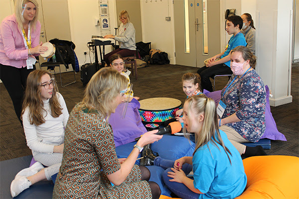 Adults & children with special needs sing and play musical instruments