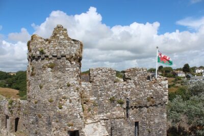 The ruins of a Welsh castle with the Welsh flag flying