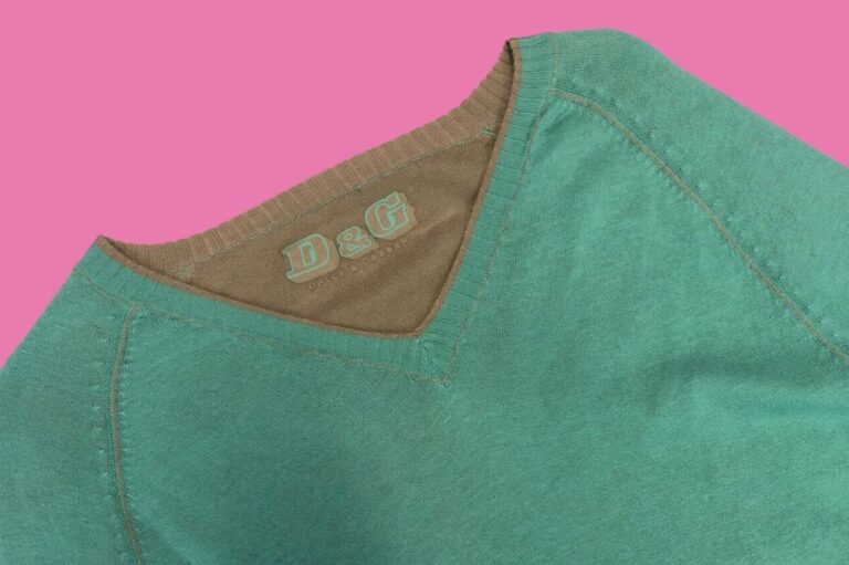 A green D&G jumper against a pink background
