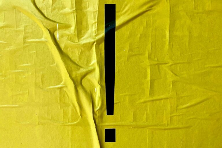 Black exclamation mark on a yellow wrinkled paper (poster?) background. Photo: Unsplash.com