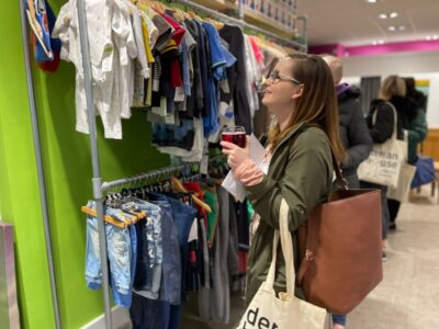 A shopper browses the clothes in a Derian House Children's Hospice shop