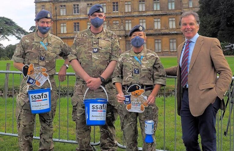 Soldiers hold donation buckets and QR codes for SSAFA