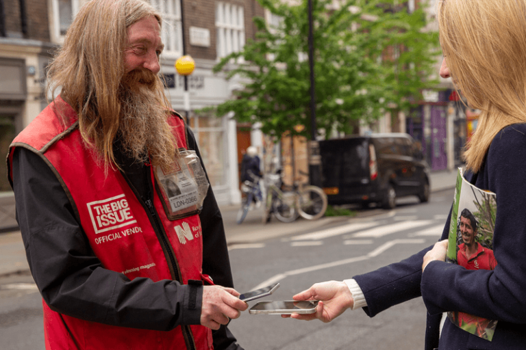 Big Issue vendor Dave takes a Tap to Pay payment with his phone