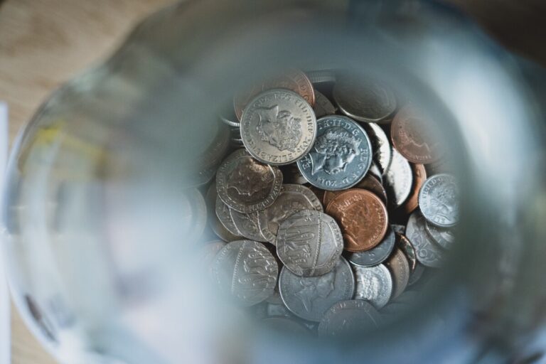 Looking down into a jar of coins. Photo by Nick Fewings on Unsplash