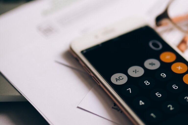 The calculator on an iphone, resting on top of some paperwork.Photo by Olya Kobruseva