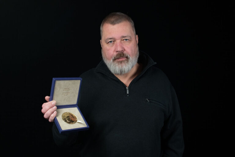 Dmitry Muratov holds his Nobel Peace PRize