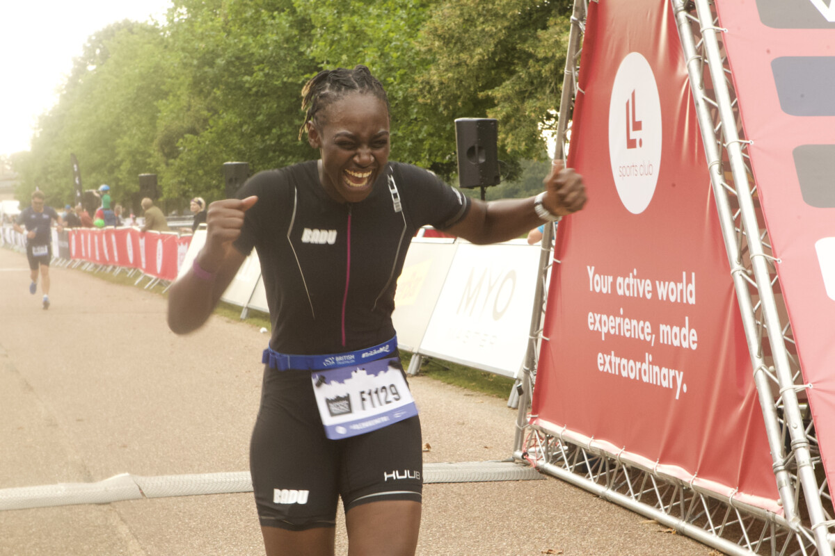 A triumphant woman runs in the London Triathlon