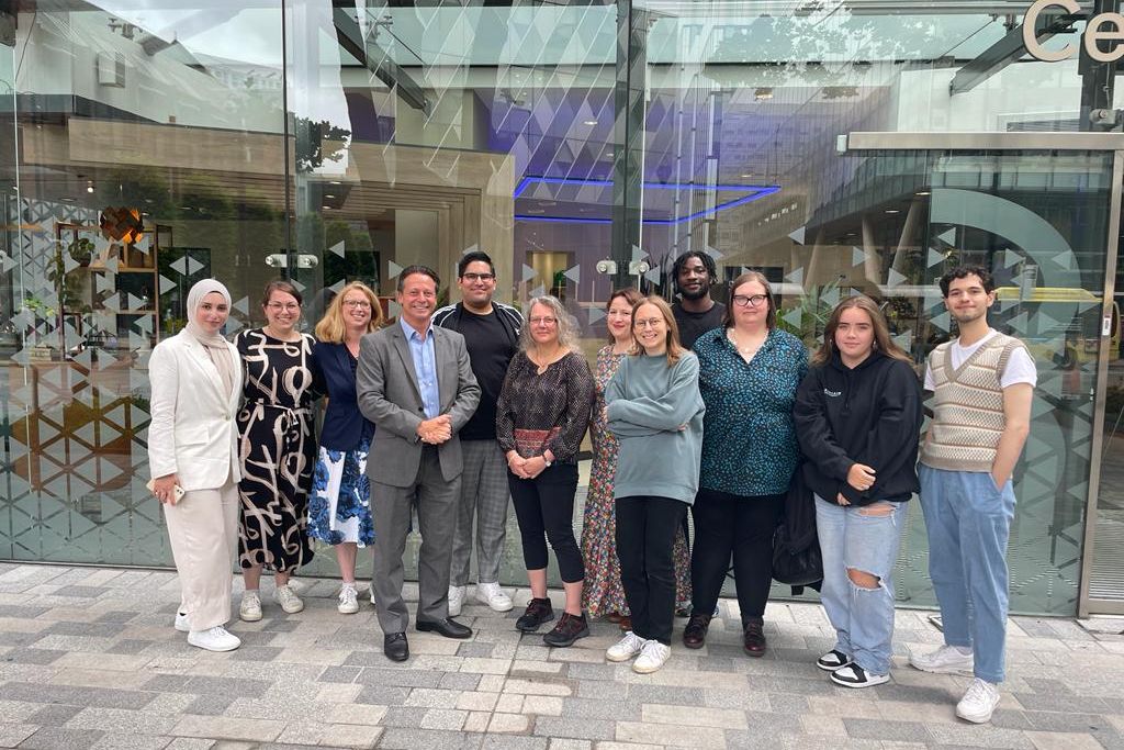 People from Young Manchester stand outside a building