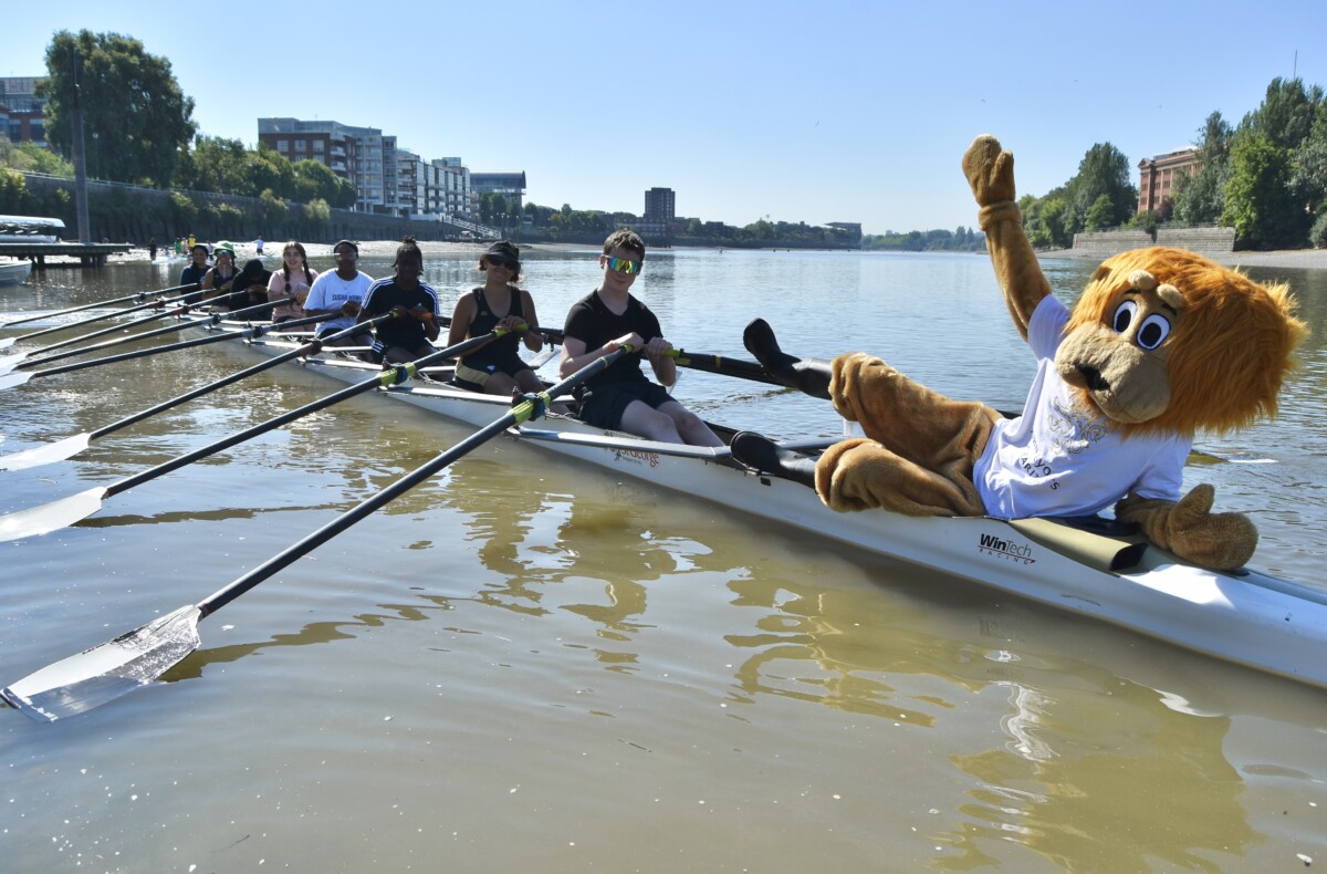 John the Lyon on a rowing boat with children. Photo: Tim Koch