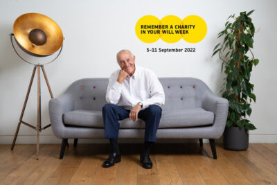 Len Goodman sits on a grey sofa for Remember A Charity Week 2022