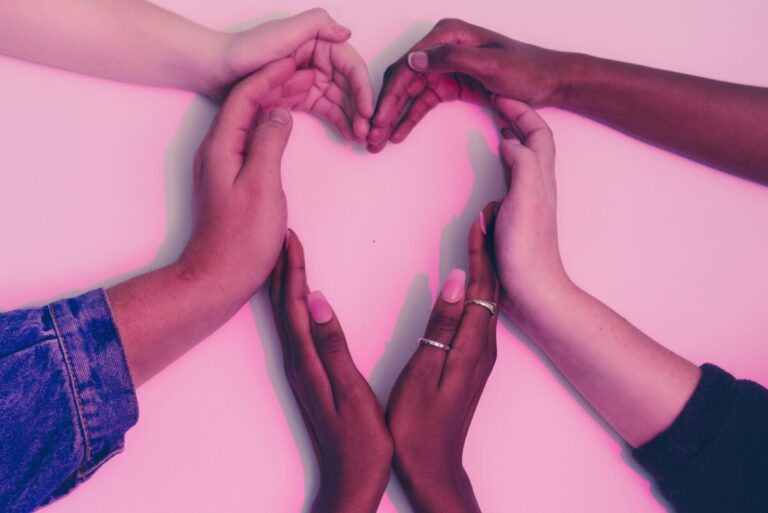 Different peoples hands combine to make a heart shape.  By ATC comm on pexels