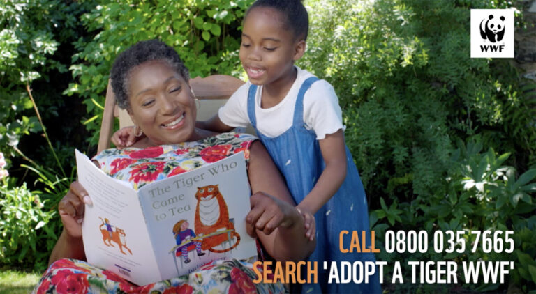 A still from a WWF TV ad showing a mother and daughter reading The Tiger Who Came to Tea