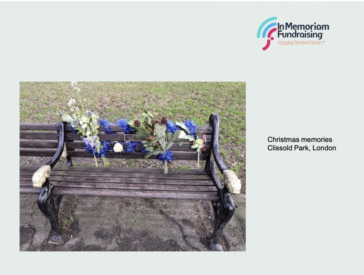Park bench in Clissold Park, with in memoriam plaque covered in Christmas flowers. Photo: Kevin Kibble