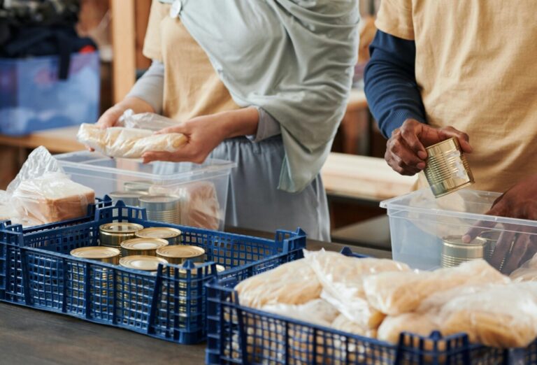 Volunteers put food donations together. By Julia M Cameron on Pexels