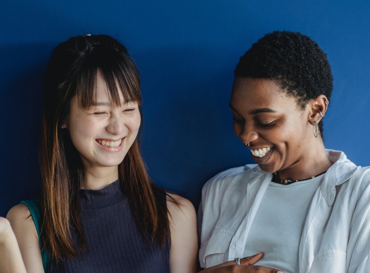 two teen girls laugh. By Zen Chung on Pexels