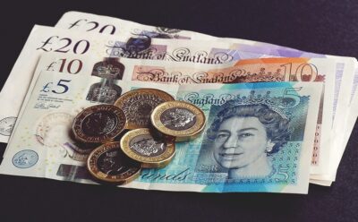 A pile of english bank notes and coins by Suzy Hazelwood on Pexels