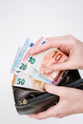 Euro notes being fanned out from a purse. Photo: Pexels.com