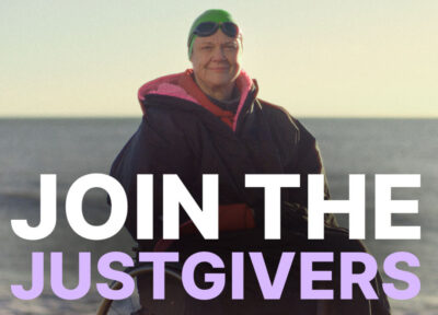Fundraiser Paula Craig in swim gear and wheelchair, faces the camera from a beach with the message Join the JustGivers over the picture