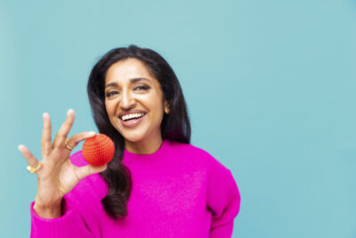 Sindu Vee supports Red Nose Day 2023 by wearing the latest Nose, this year being provided by Amazon. Photo by Jake Turney/Comic Relief.