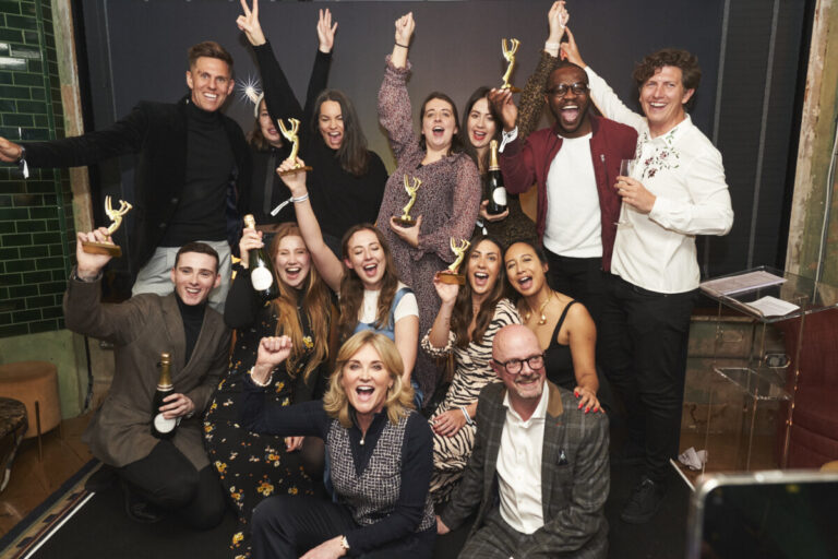 Winners of the EMMAS celebrate in a group shot, with awards