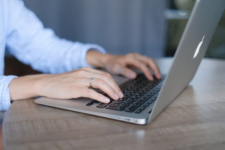 A woman's hands typing on a laptop keyboard. By Anna Shvets on Pexels