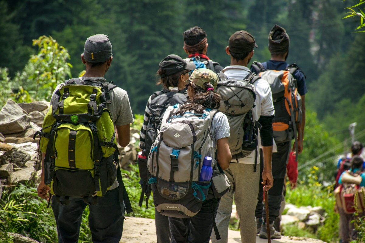 A group of hikers head towards woodland. By Guduru Ajay Bhargav on Pexels