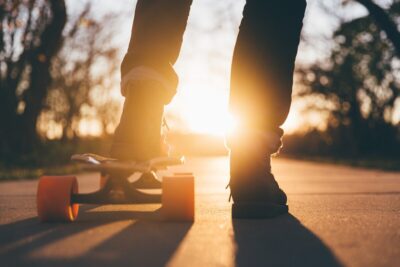 A boy on a skateboard with a low sun. By pexels on Pixabay