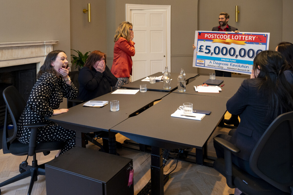 Pictured: People's Postcode Lottery Ambassador Matt Johnson presents a dream fund cheque to the Alzheimer's Society & Alzheimer's Research UK. Pictures copyright ©Darren Casey / PPL