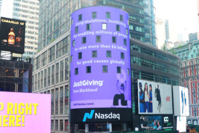 JustGiving ad on nasdaq tower in purple