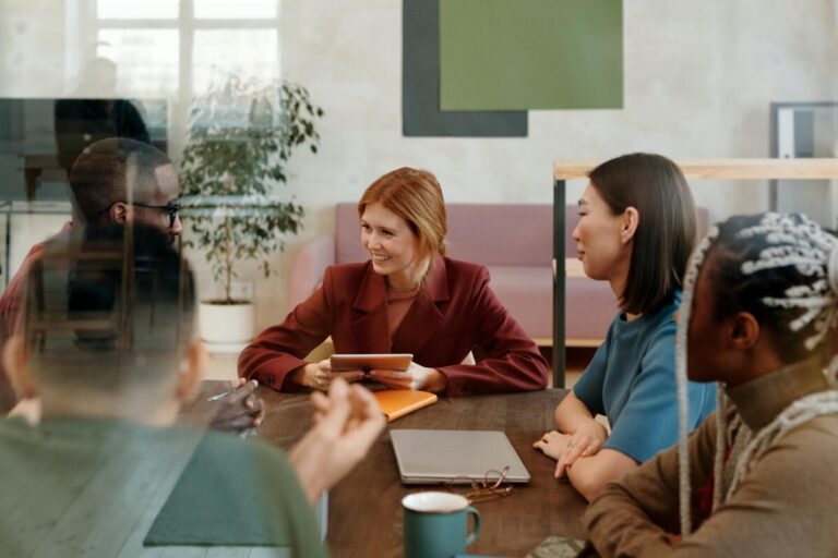 A photo of a group of people having a meeting by Diva Plavalaguna on Pexels