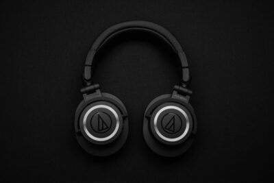Black headphones against a black background