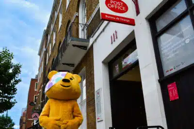 Pudsey Bear outside a Post Office